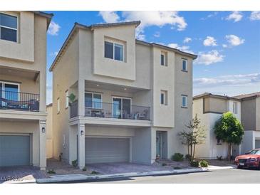 Modern two-story home with a balcony, neutral stucco, and an attached garage, offering contemporary living at 6848 Sunflower Fields St, North Las Vegas, NV 89086