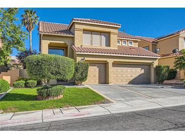 Charming two-story home features a two-car garage, well-manicured lawn, and desert landscaping at 10241 Regents Cross Pl, Las Vegas, NV 89144