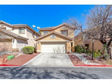 Charming two-story home featuring a two-car garage, landscaped yard, and desert landscaping at 11028 Meadow Leaf Ave, Las Vegas, NV 89144