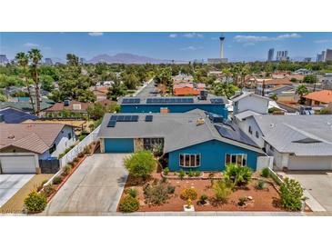 Charming blue two-story home with solar panels and desert landscaping in Las Vegas at 1601 Eaton Dr, Las Vegas, NV 89102