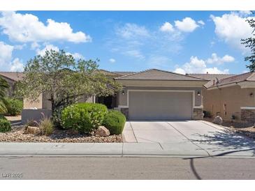 Beautiful single-story home with a two-car garage, desert landscaping and a tile roof at 2108 Willow Wren Dr, North Las Vegas, NV 89084