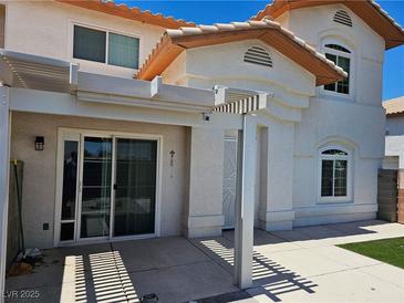 Inviting home exterior with a covered patio and stucco siding with great curb appeal at 236 Star Cluster Cir, Las Vegas, NV 89145