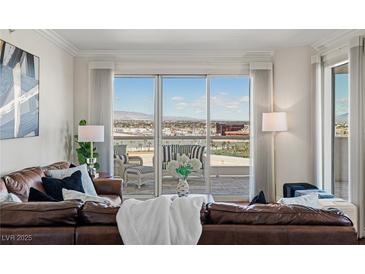 Bright living room featuring a brown leather couch, floor-to-ceiling windows, and an amazing city view at 2777 Paradise Rd # 1105, Las Vegas, NV 89109