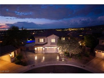 Elegant two-story home at dusk with a three-car garage and beautifully landscaped front yard at 2900 Valvent Ct, Henderson, NV 89044