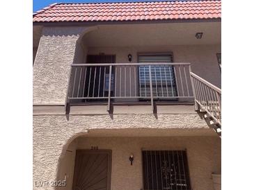 Multi-story home featuring stucco siding, a red tile roof, and secure gated entryways at 4300 N Lamont St # 249, Las Vegas, NV 89115