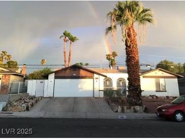 Charming single-story home featuring a spacious driveway and beautiful landscaping at 4461 Greenhill Dr, Las Vegas, NV 89121