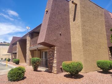 Multi-level apartment building with brown and tan exterior walls, balconies, and manicured shrubbery at 5188 River Glen Dr # 453, Las Vegas, NV 89103