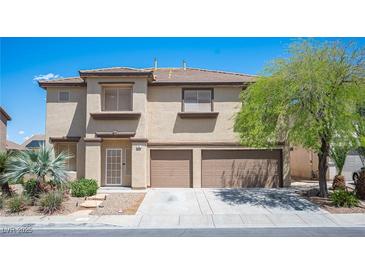Two-story home featuring desert landscaping, a two-car garage, and a neutral color palette at 54 Blue Fountain Ct, Henderson, NV 89012