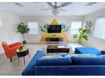 Bright living room with tropical-themed wall decor, stylish furnishings and hardwood flooring at 7319 Burnt Umber St, Las Vegas, NV 89139