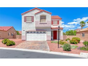 Charming two-story home boasts colorful accents, landscaped yard, and a two-car garage at 7892 Villa Salsa Ave, Las Vegas, NV 89131