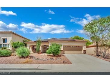 Charming single-story home with a well-manicured desert landscape and two car garage at 9142 Royal Monarch Ct, Las Vegas, NV 89147