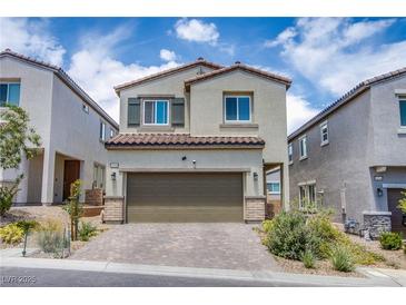 Charming two-story home featuring desert landscaping, a tile roof and a two car garage at 10590 Dryades Ave, Las Vegas, NV 89166