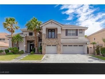 Two-story home with a three-car garage, stone accents, balcony, and palm trees at 10761 Capesthorne Way, Las Vegas, NV 89135