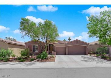 Charming single-story home with a well-manicured front yard and a two-car garage at 11244 Gammila Dr, Las Vegas, NV 89141