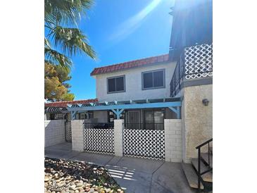 Two-story house with a red tile roof and small fenced yard at 1128 Willow Tree Dr # C, Las Vegas, NV 89128