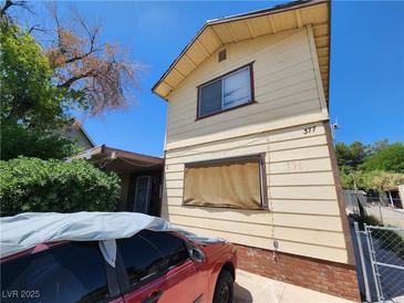 Two-story home featuring wood siding with brick foundation accents at 377 N 16Th St, Las Vegas, NV 89101