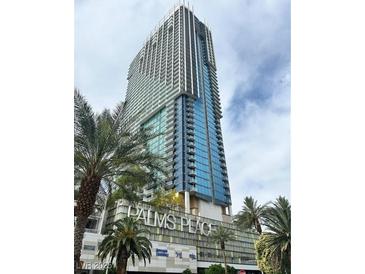Stunning view of the Palms Place Las Vegas condo building with modern architectural design and palm trees at 4381 W Flamingo Rd # 1101, Las Vegas, NV 89103