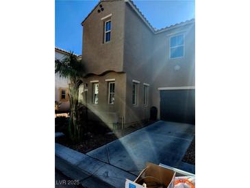 Charming two-story home with a desert-landscaped yard and inviting curb appeal on a sunny day at 5380 Flowing Spring St, Las Vegas, NV 89122