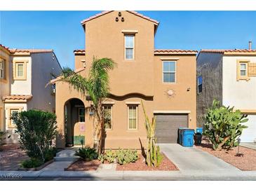 Charming two-story home with a landscaped front yard, driveway, and attached garage at 5380 Flowing Spring St, Las Vegas, NV 89122