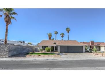 Charming single-story home featuring a well-maintained front yard and a two-car garage at 6842 Greengrove Dr, Las Vegas, NV 89103