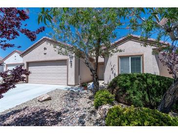 Charming single-story home featuring low-maintenance desert landscaping, neutral stucco, and an attached two-car garage at 7448 Lintwhite St, North Las Vegas, NV 89084