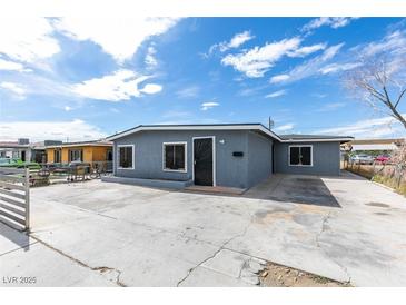 Charming single-story home with a freshly painted gray exterior and ample parking space at 1013 Cunningham Dr, Las Vegas, NV 89106