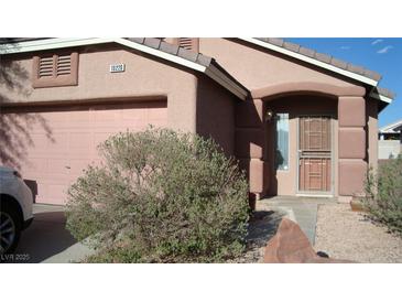 Charming single-story home with a stucco facade, arched entryway, and a well-manicured front yard at 10220 Arlington Abby St, Las Vegas, NV 89183