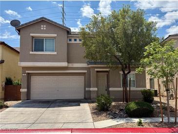 Inviting two-story home featuring an attached two-car garage and desert landscaping at 125 Sharp Edge Ave, North Las Vegas, NV 89031