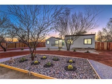 Charming home featuring xeriscaped yard with native plants and decorative rock at 1731 Sherwin Ln, Las Vegas, NV 89156