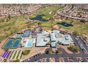 Expansive aerial view of community amenities featuring golf course, pool, clubhouse, and tennis and pickleball courts at 2185 High Mesa Dr, Henderson, NV 89012