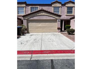 Inviting townhouse featuring a two-car garage and well-maintained front yard at 2528 Sierra Bello Ave # 103, Las Vegas, NV 89106