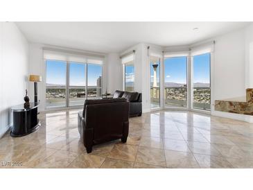 Bright living room features floor-to-ceiling windows with stunning city views and comfortable seating at 2777 Paradise Rd # 2605, Las Vegas, NV 89109