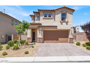 Two-story home featuring a brown garage door, stucco siding, and landscaped front yard at 3002 Coveri Ct, Las Vegas, NV 89141