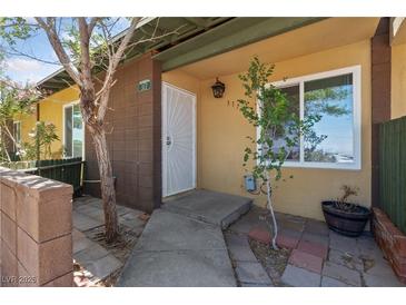 Inviting front entrance with a secure white door and well-maintained landscaping at 317 E Van Wagenen St, Henderson, NV 89015