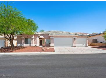 Charming single-story home with a three-car garage, well-maintained landscaping, and a neutral color scheme at 3431 Cottage Thistle Dr, Laughlin, NV 89029