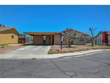 Charming single-story home with a covered parking and a well-maintained front yard in a suburban neighborhood at 3630 N Pecos Rd, Las Vegas, NV 89115