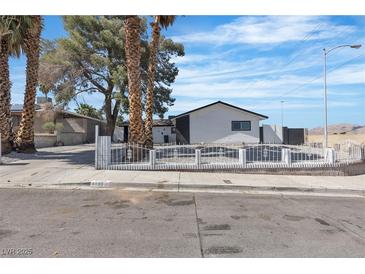 Charming home featuring a white picket fence, mature trees, and a well-maintained yard at 4186 Toronto Cir, Las Vegas, NV 89121