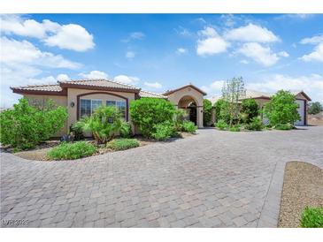 Beautiful single story home with a brick driveway and plenty of vegetation at 4455 W Ford Ave, Las Vegas, NV 89139