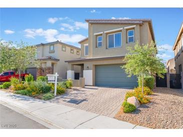 Charming two-story home featuring a manicured yard, two-car garage, and inviting curb appeal at 4524 Stardusk Falls Ave, North Las Vegas, NV 89084