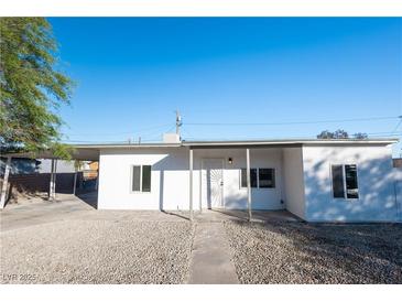 Charming single-story home with a clean white facade and a well-maintained gravel front yard at 54 E Texas Ave, Henderson, NV 89015