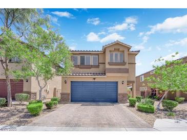 Inviting two-story home with a blue garage door, stone accents, and a well-maintained front yard at 6626 Seahorse Reef St, Las Vegas, NV 89149