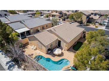 Aerial view of the kidney-shaped pool and patio area in the backyard of this single-story home at 8266 Lincoln Valley St, Las Vegas, NV 89123