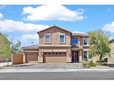 Two-story home featuring a three-car garage and well maintained landscape at 1020 High Altitude Ave, North Las Vegas, NV 89032