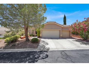 Charming single-story home featuring a three car garage and mature landscaping at 10805 Hollow Creek Ln, Las Vegas, NV 89144