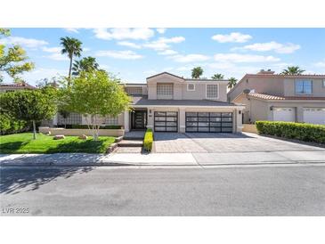 Beautiful two-story home with well-maintained landscaping, a three-car garage, and a spacious driveway at 188 Carthage St, Henderson, NV 89074