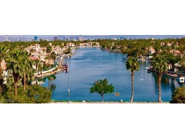 A scenic view of a waterfront community, featuring palm trees, and a lake at 3005 Treasure Island Rd, Las Vegas, NV 89128