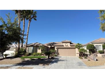 Charming single-story home featuring a well-maintained landscape, desert plants and a two car garage at 4299 Fiore Bella Blvd, Las Vegas, NV 89135