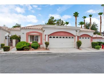 Charming home featuring a two-car garage, lush landscaping, and a welcoming entrance, perfect for suburban living at 5161 Briar Meadow Way, Las Vegas, NV 89118