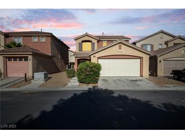 Inviting two-story home featuring a two-car garage, desert landscaping, and a cozy front entryway at 5573 La Perla Ct, Las Vegas, NV 89122