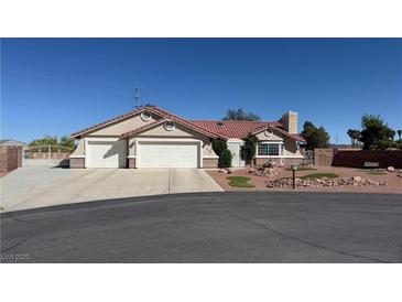 Charming single story home with a three car garage, well manicured landscape, and a tile roof at 9180 Mohawk St, Las Vegas, NV 89139
